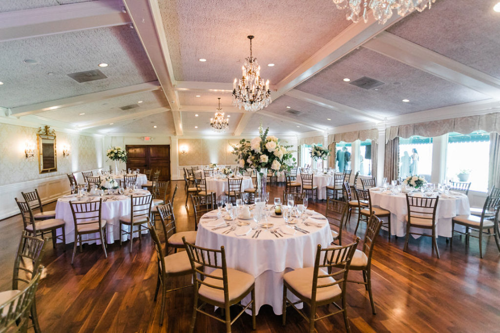 Ballroom featuring White, ivory and green high centerpieces at Oakmont Country Club wedding