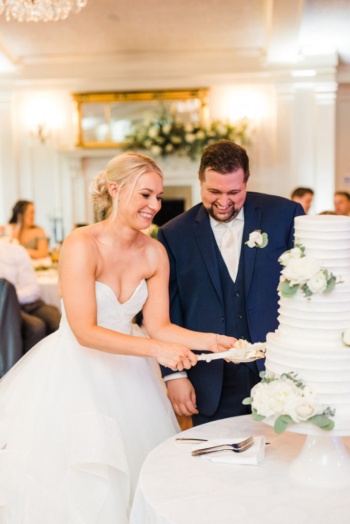 Bride and groom cut their cake together at Oakmont Country Club Wedding