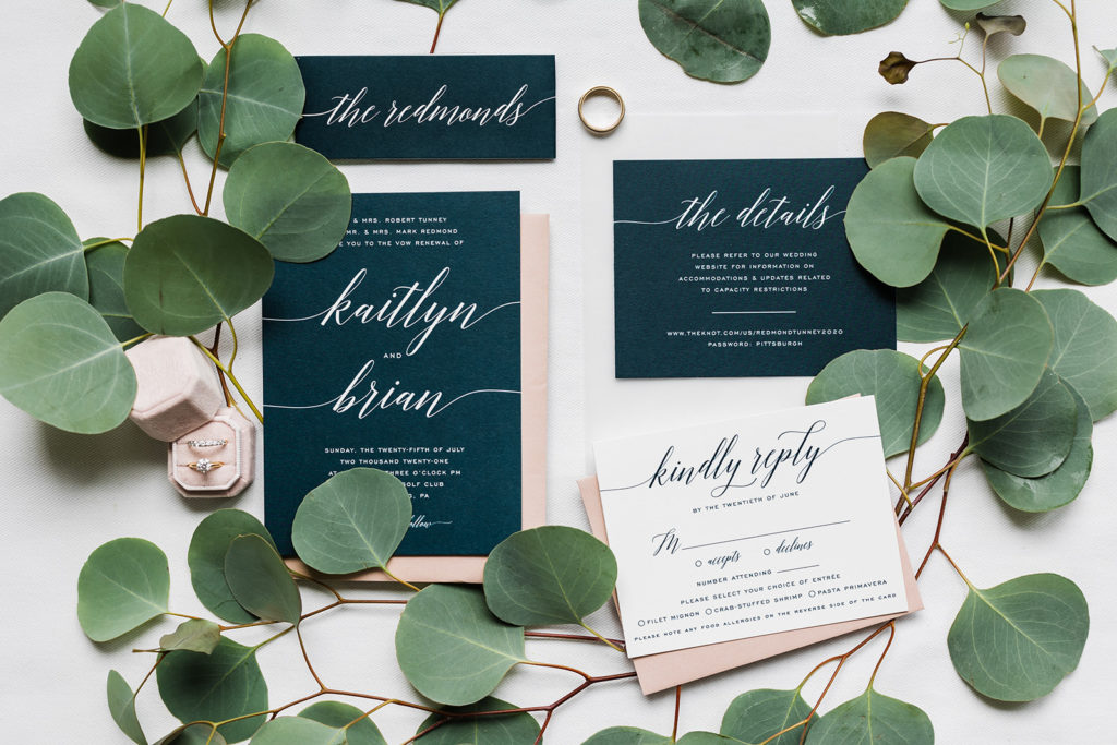Flat lay of navy, ivory and light pink bridal stationery