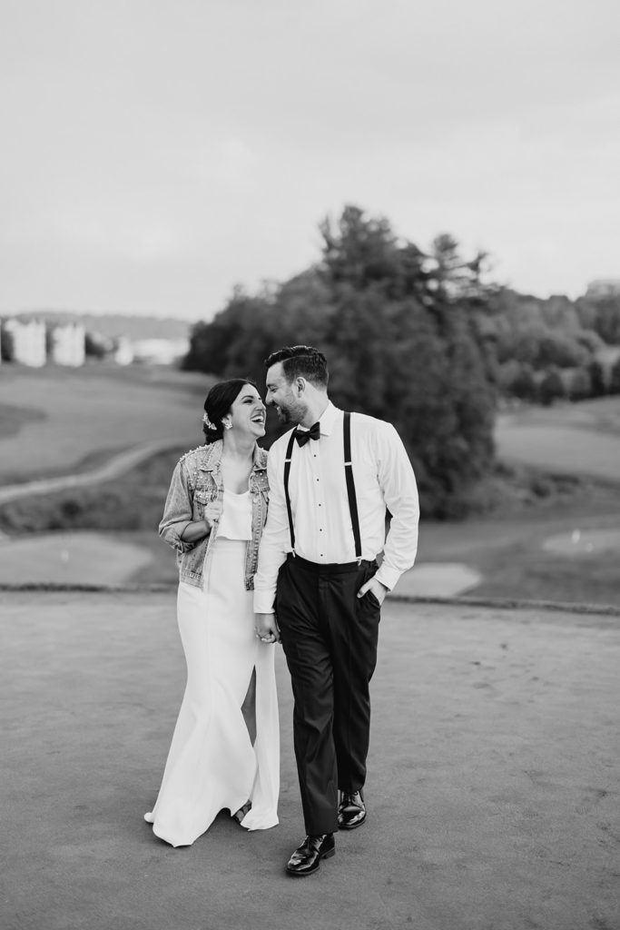 Bride and groom share intimate moments outside their reception at sunset