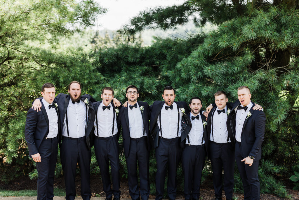 Groom and groomsmen stand together outside Southpointe Golf Club