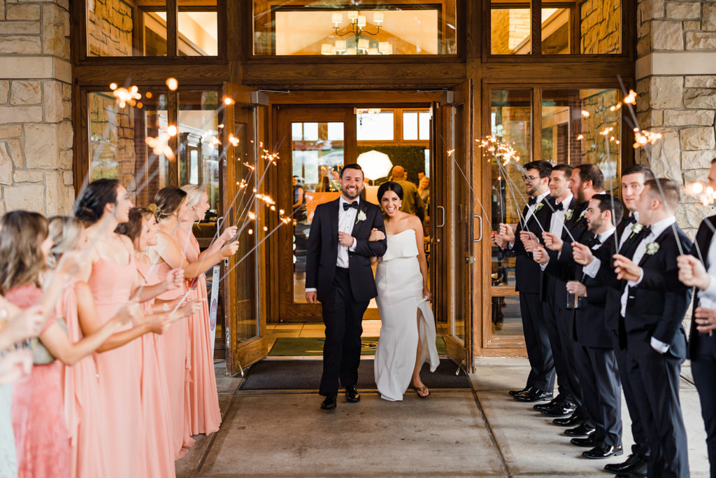 Bride and groom walk through sparkler exit at Southpointe Golf Club