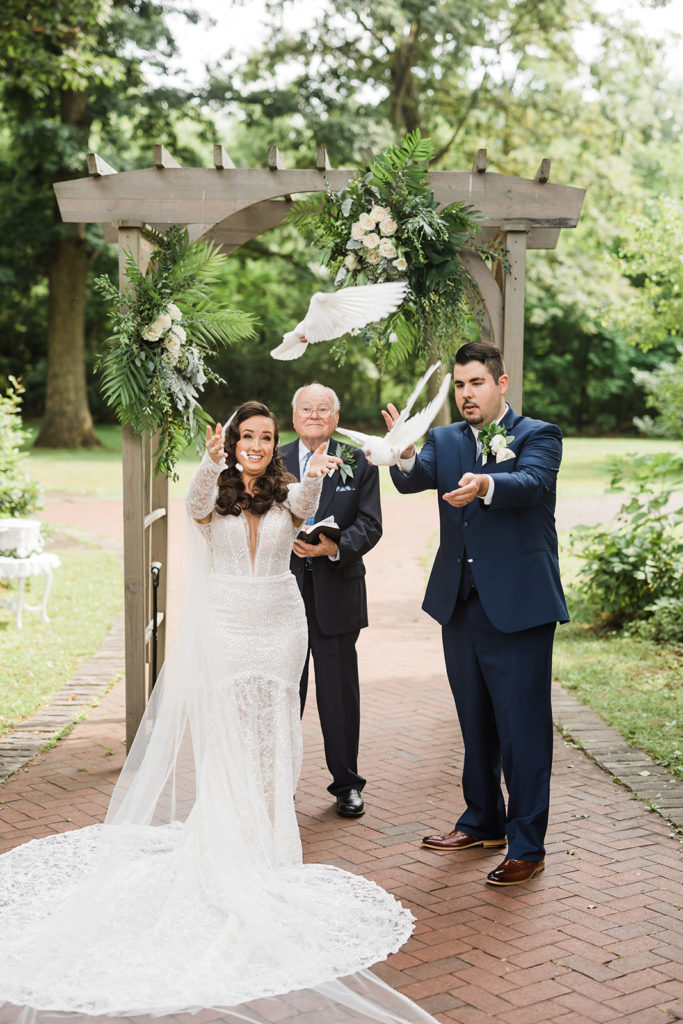 Bride and groom release doves during ceremony at Succop Nature Park