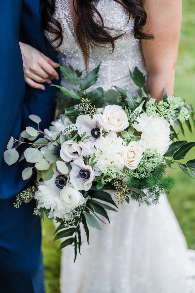 Close up photo of white and green bridal bouquet