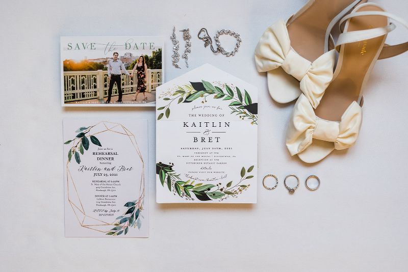 Stationery flat lay with brides shoes and jewelry