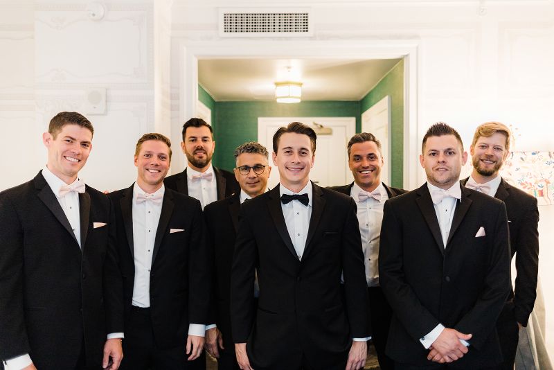 Groom smiles with his groomsmen in the Hotel Monaco Pittsburgh