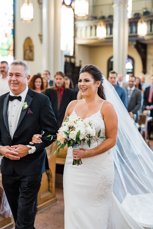 Bride and her father walk down the aisle of the Saint Mary on the Mount church