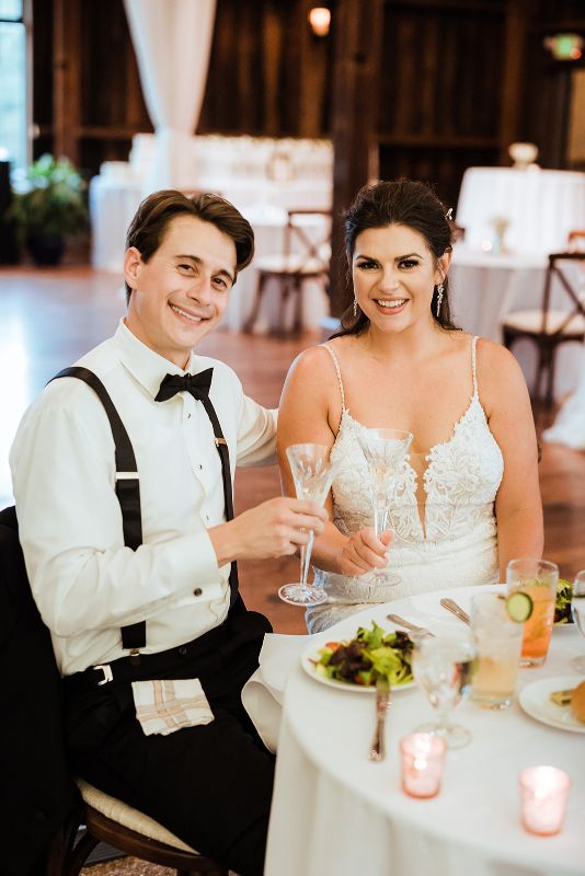 Bride and groom toast at their summer Pittsburgh Botanic Garden wedding