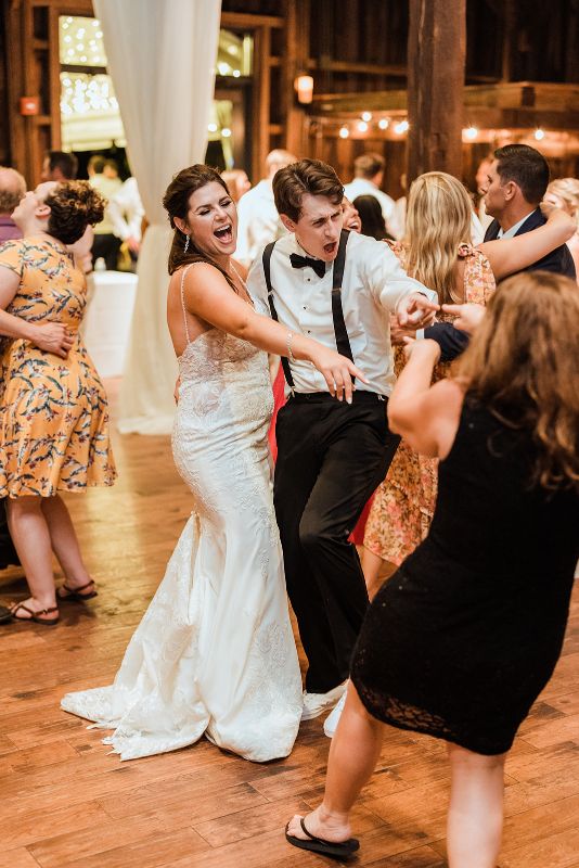 Bride and groom dance together with guests at Pittsburgh Botanic Garden