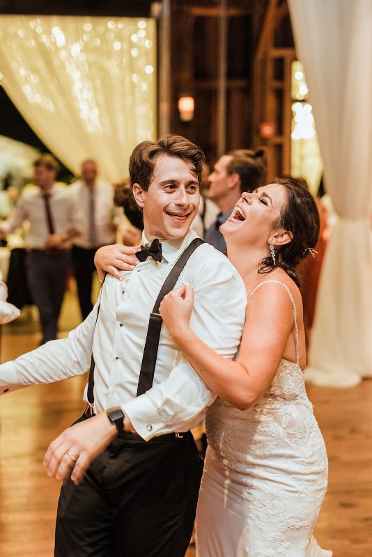 Bride and groom dance together with guests at Pittsburgh Botanic Garden