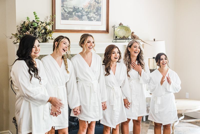 Bridesmaids react as they see the bride for the first time