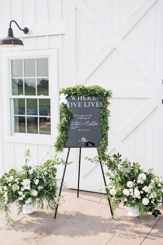 Outdoor signage at summertime Grayson House wedding reception 