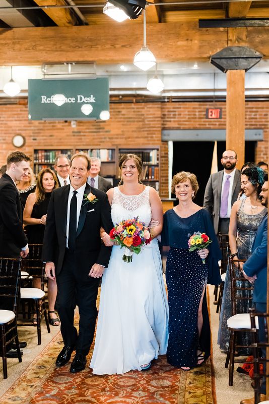 Bride walks down the aisle with her parents at Heinz History Center wedding