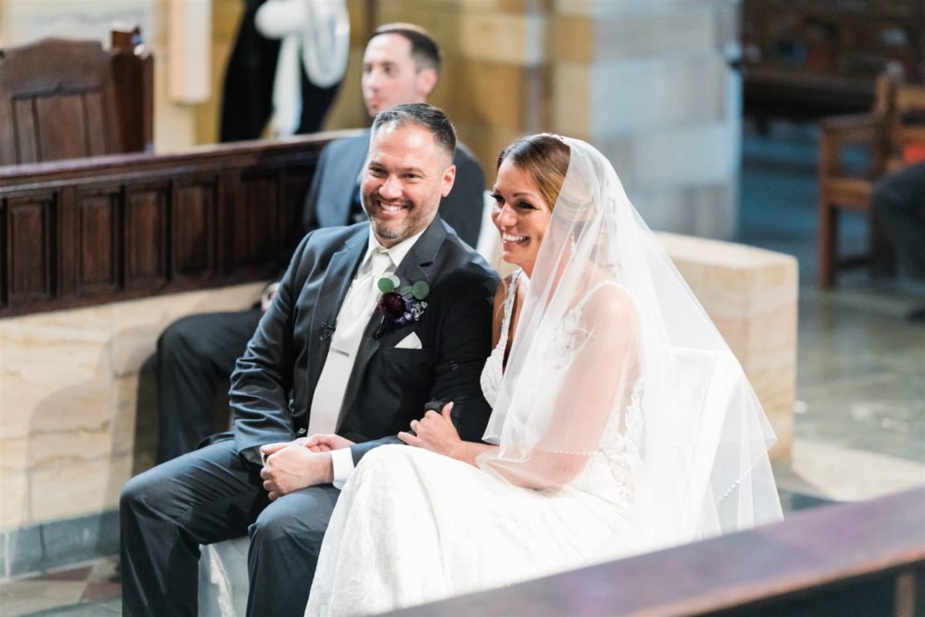 Bride and groom laugh together in wedding ceremony at Sacred Heart Parish