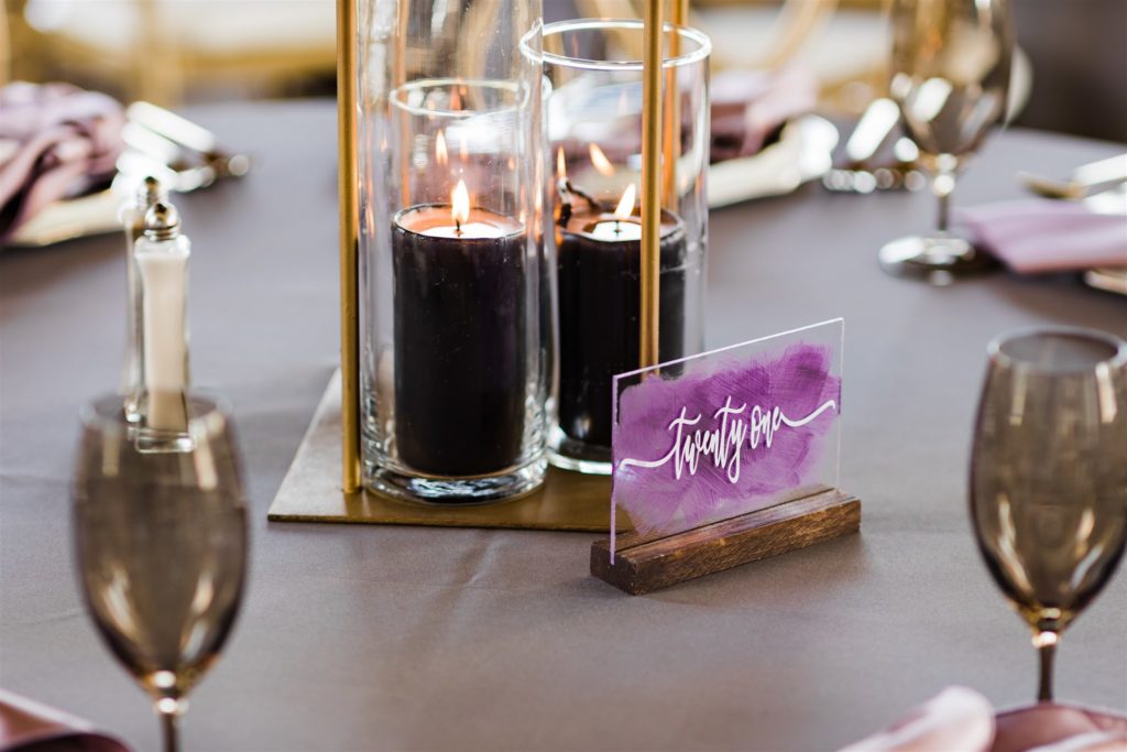 Candles, acrylic table numbers and gold details
