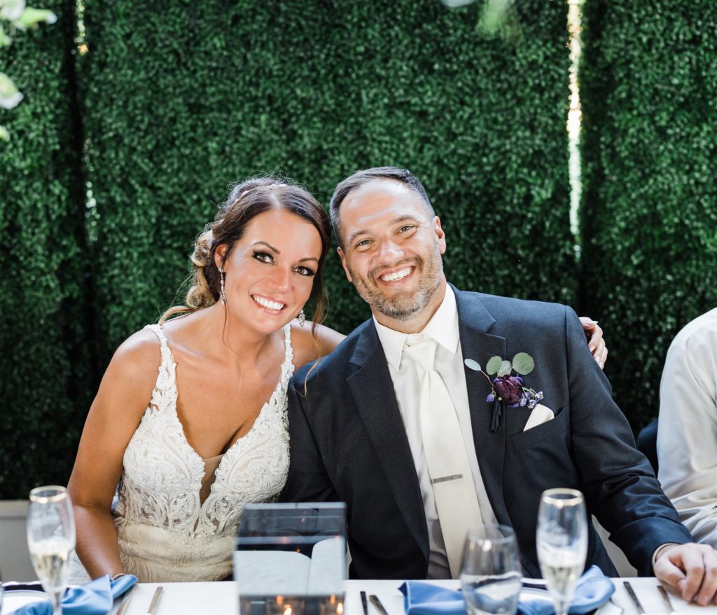 Bride and groom smile at their head table at Aspinwall Riverfront Park Wedding