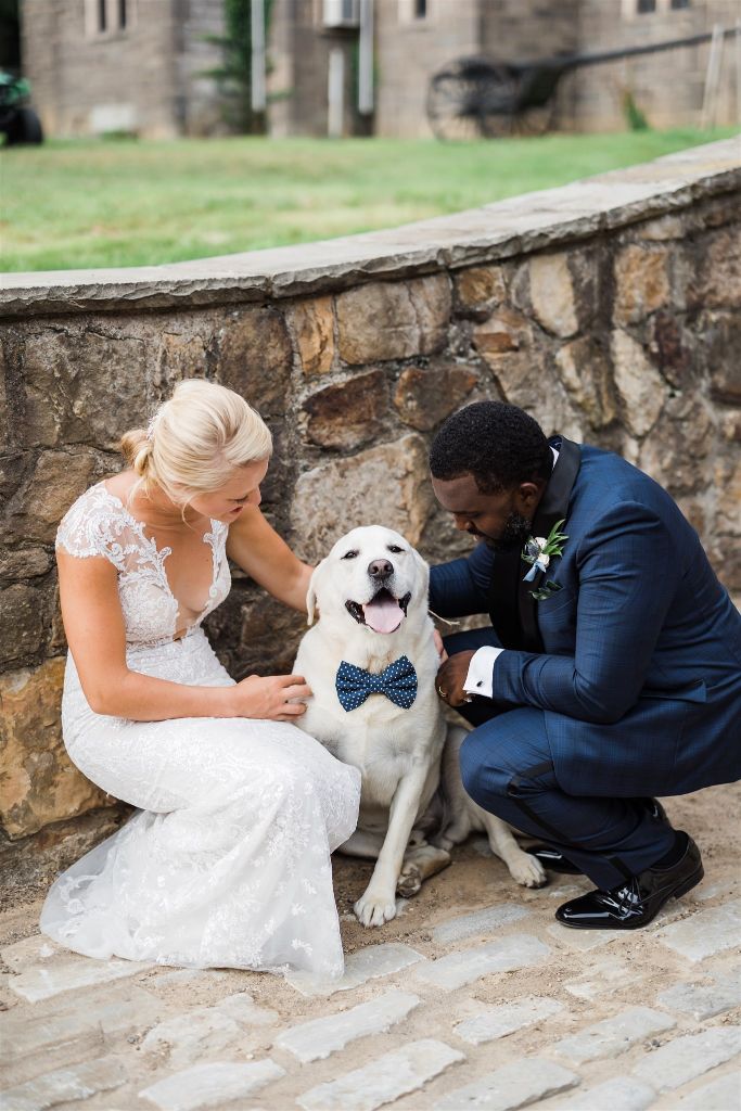 Couple poses with their dog at Stables at Hartwood Wedding