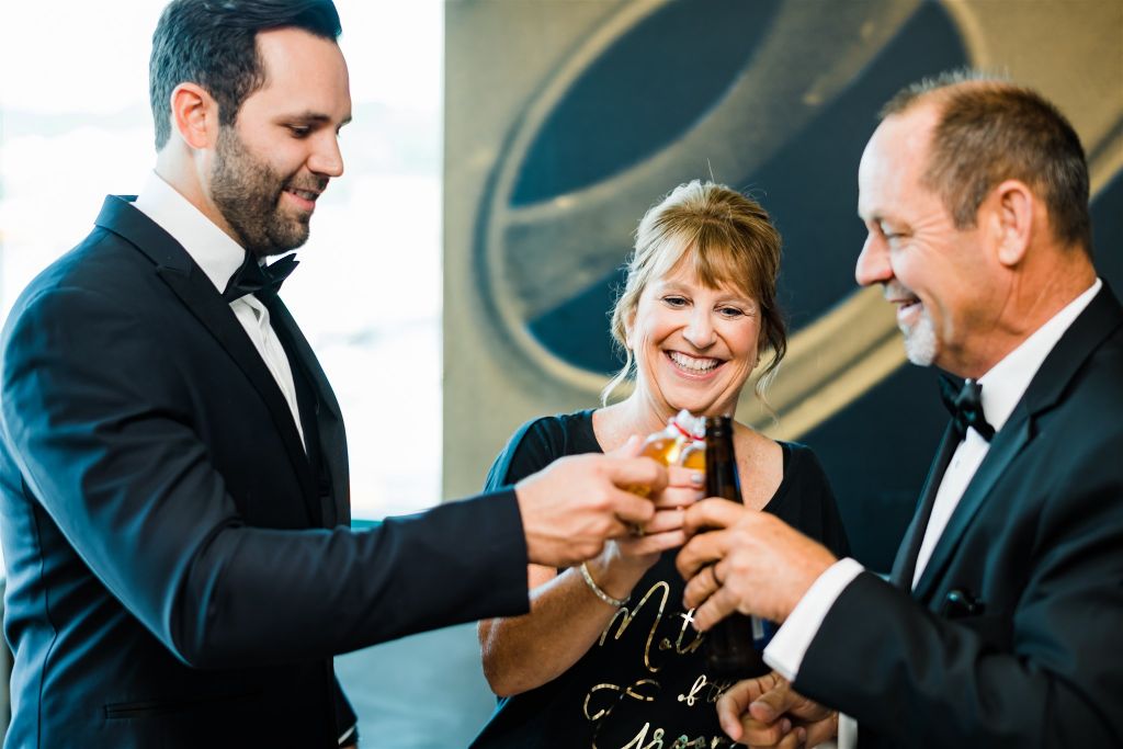 Groom toasts with parents before the wedding ceremony