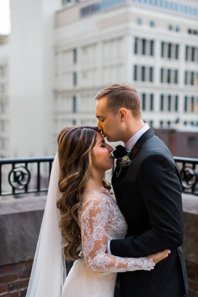 Bride and groom share an intimate moment on the Duquesne Club balcony