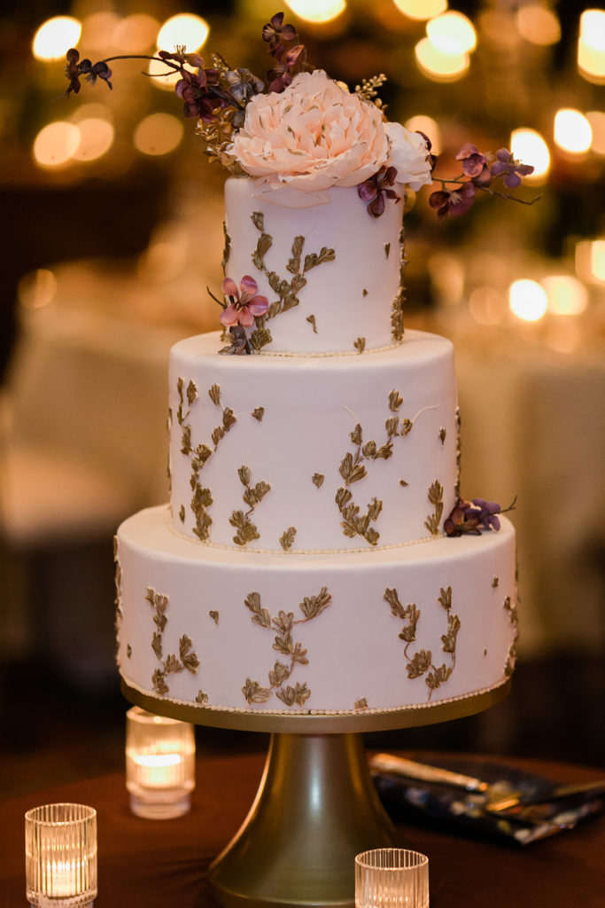 Duquesne Club gold foil cake topped with icing florals