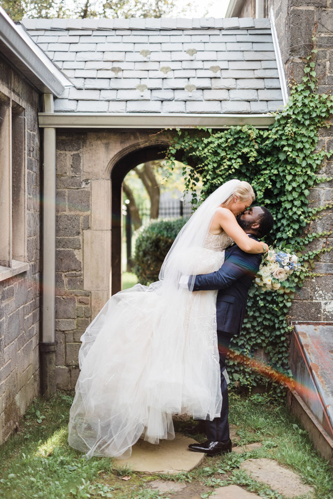 Bride and groom pose in the archways at the Stables at Hartwood Acres
