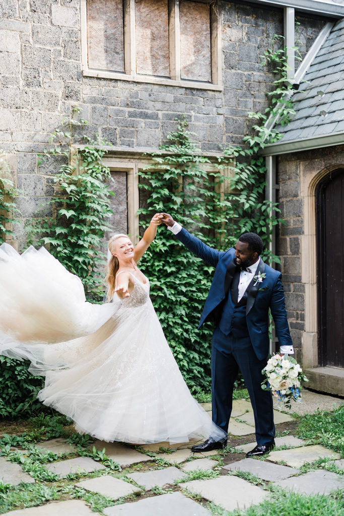 Groom spins bride outside Stables at Hartwood Acres