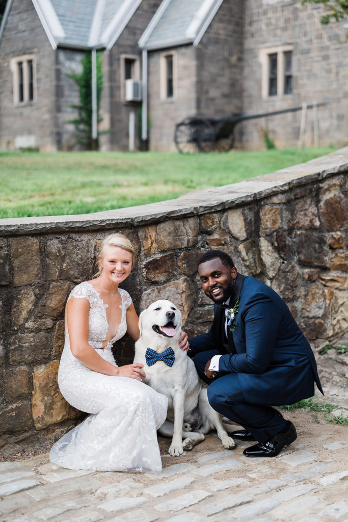 Bride and groom pose with dog at Stables at Hartwood Acres