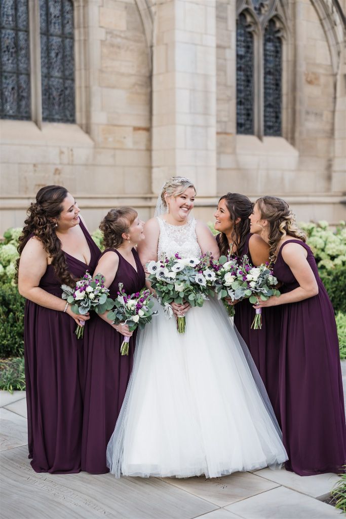 Bride and bridesmaids pose together outside classic Heinz Chapel wedding