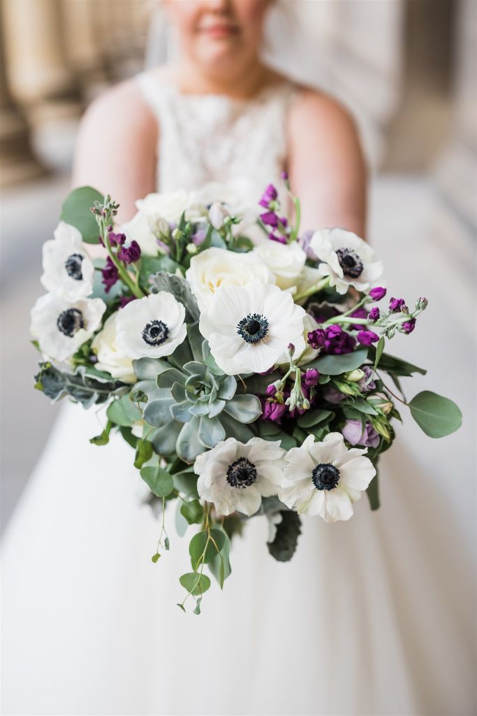 Photo of brides hands holding large bouquet from Gidas Flowers