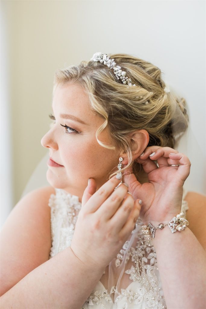 Bride fastens her earring