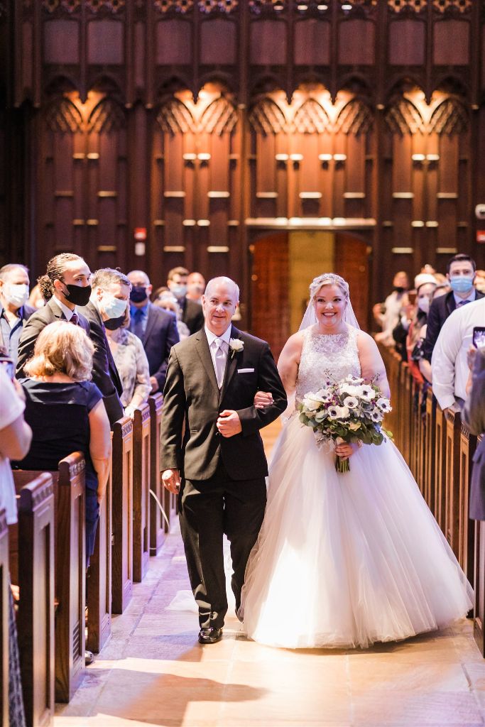 Bride and her father smile as she walks down the aisle at their classic Heinz Chapel wedding