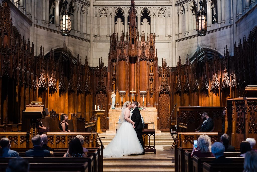 Bride and groom share first kiss as husband and wife at their classic Heinz Chapel wedding