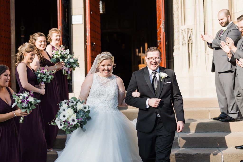 Bride and groom walk down the steps of their classic Heinz Chapel wedding