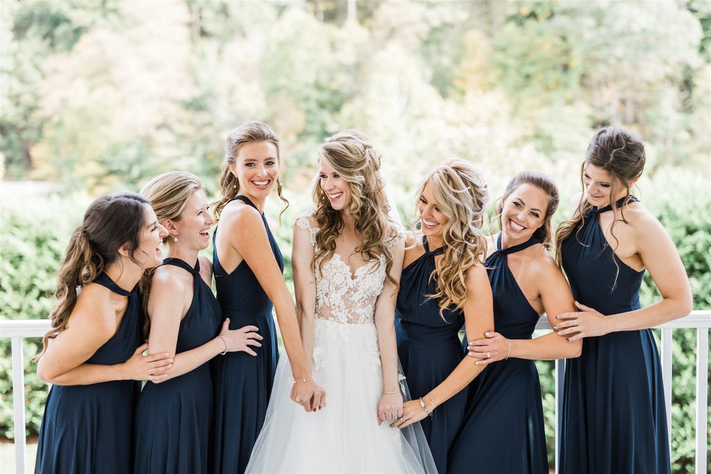 Bride and bridesmaids laugh together