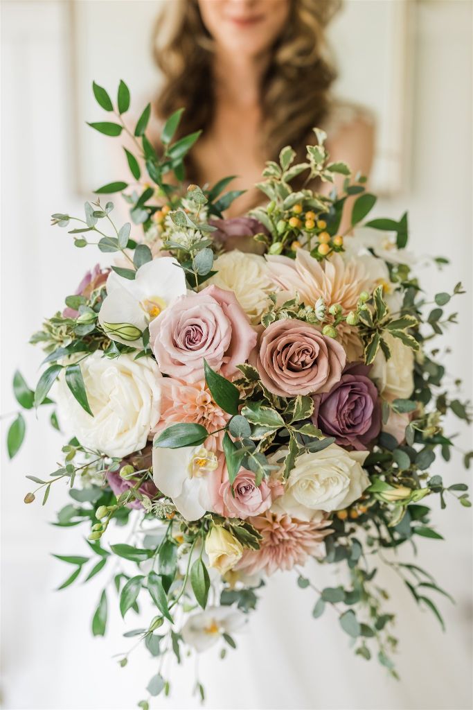 Close up photo of white, pink and green wedding bouquet