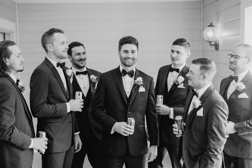 Groom and his groomsmen laugh together before the wedding begins