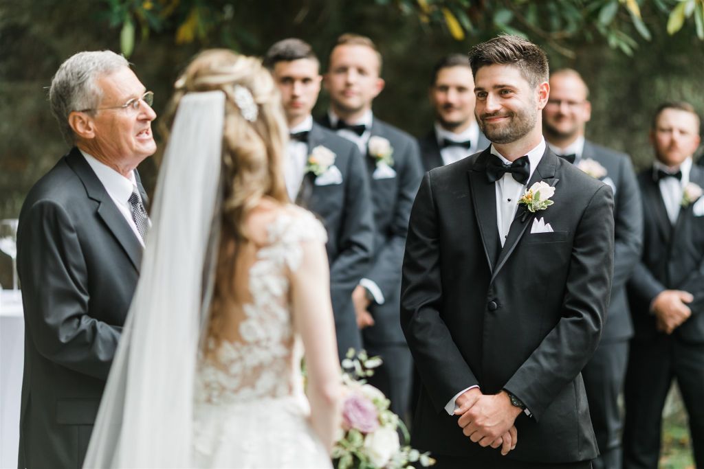 Groom looks adoringly at the bride during ceremony