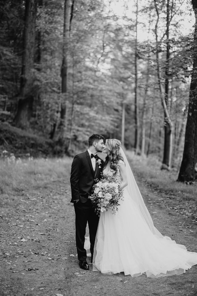 Bride and groom kiss near the grotto at Omni Bedford Springs hotel