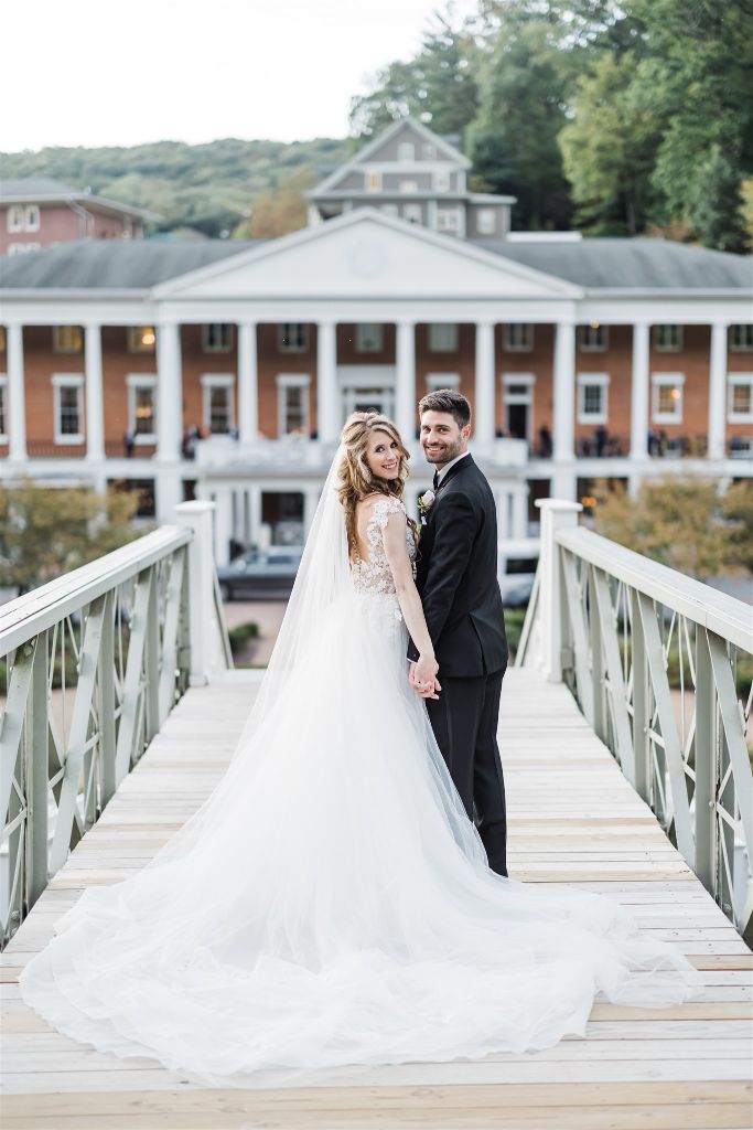 Bride and groom pose in front of Omni Bedford Springs hotel