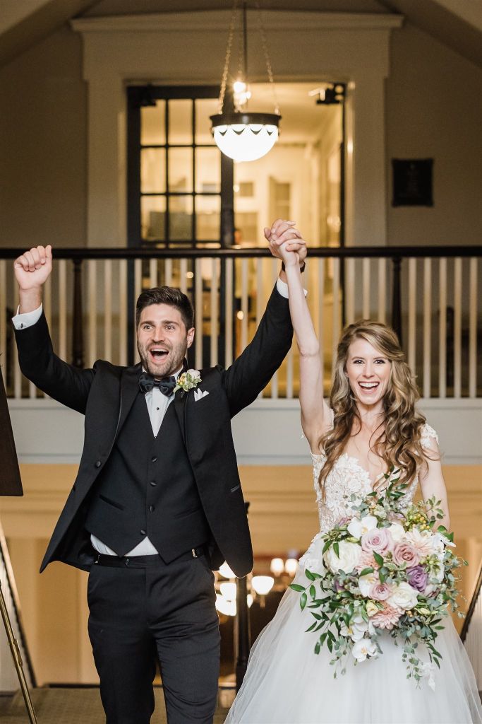 Bride and groom cheer as they enter their reception at wedding at Bedford Springs wedding