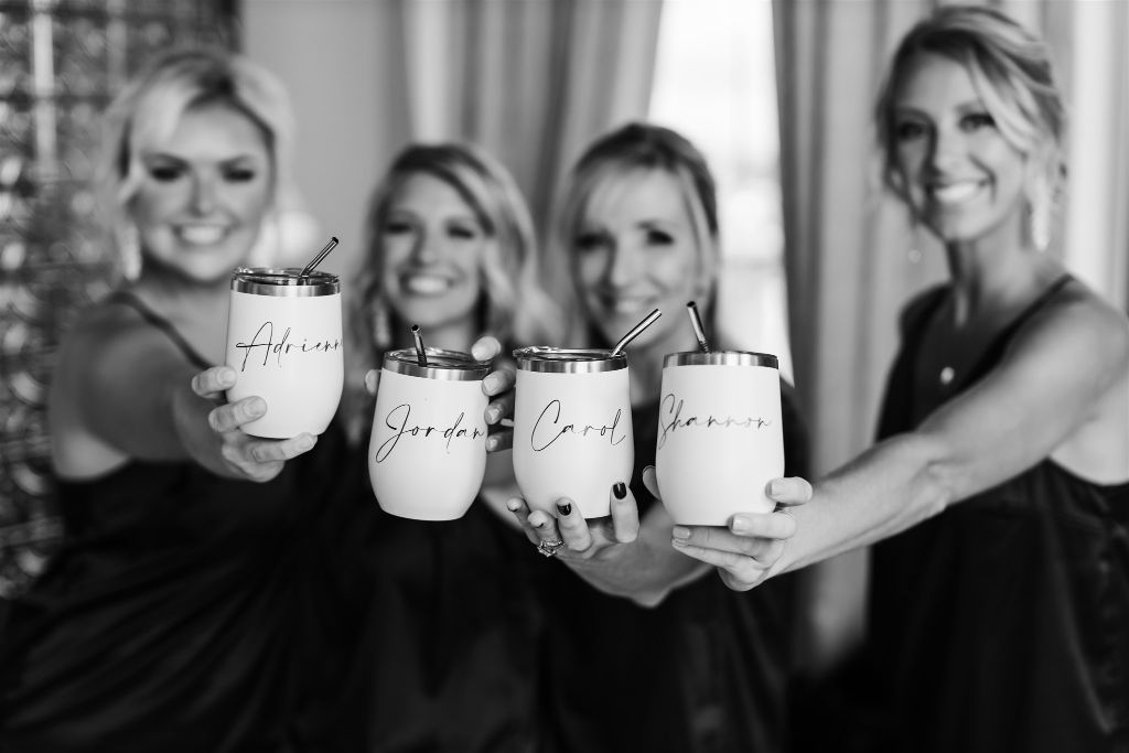 Bridesmaids hold up custom coffee cups