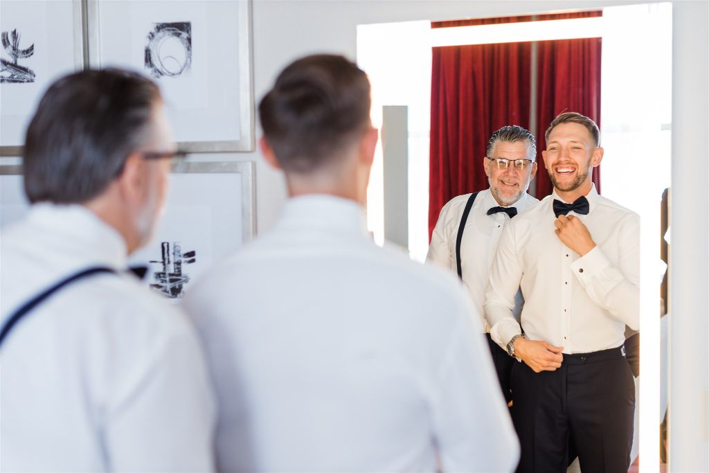 Groom and his father share a special moment together while getting ready