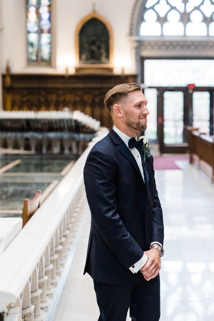 Groom holds back emotion as he see's the bride for the first time