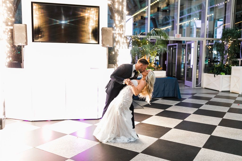 Groom kisses bride at wedding at PPG Wintergarden