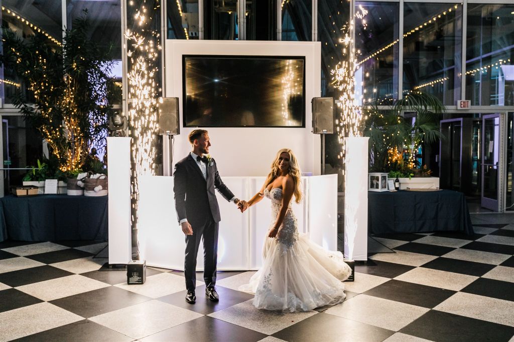Bride and groom enter reception at PPG Wintergarden