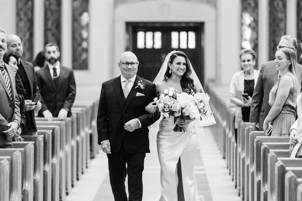 Bride and her father walk down the aisle at Assumption Catholic Church wedding