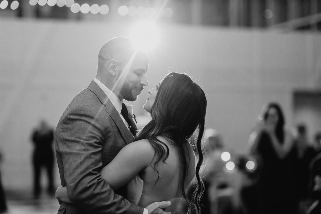 Bride and groom share intimate moment together during first dance at PPG Wintergarden