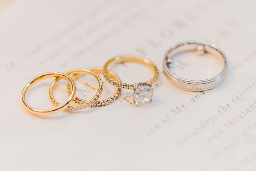Macro photo of wedding rings on invitation suite