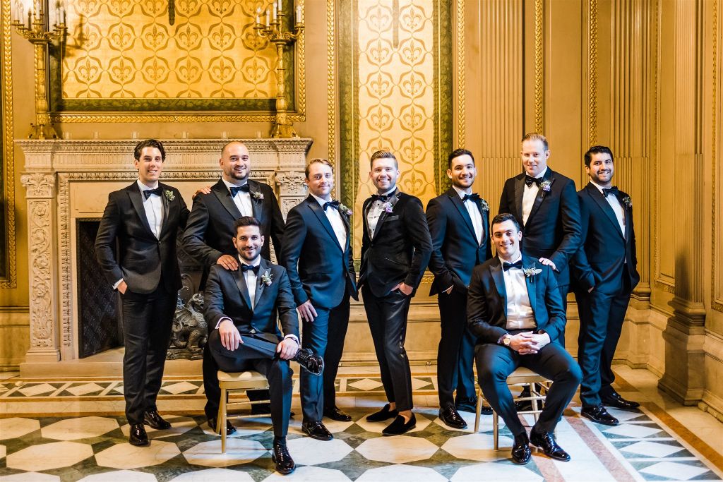 Groom and groomsmen pose together at Carnegie Museum