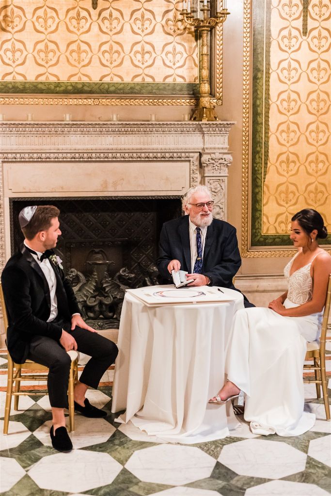 bride and groom sign ketubah at Jewish wedding at the Carnegie